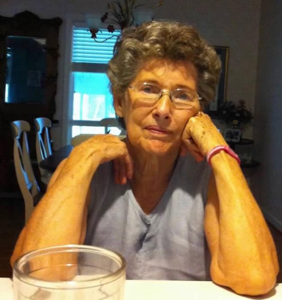 My grandmother sitting at the kitchen bar in her home.